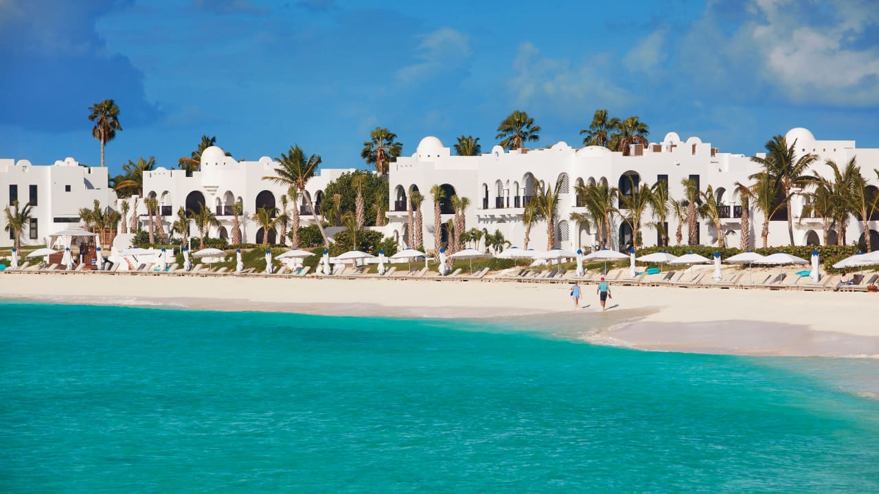 Exterior shot of Belmond Cap Juluca, Couple walking on beach