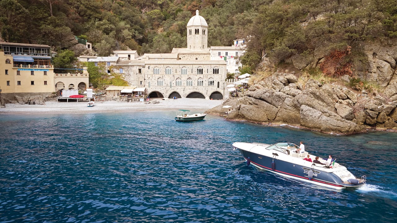 Boat approaching a rocky bay near Portofino