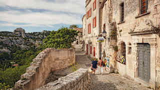 Aerial view of sandstone residences with wooden shutters in a rural French village