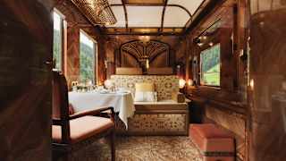 With walnut panelling, russet velvet seats and a carpet in swirling mushroom shades, La Forêt Suite glows with warm  tones.