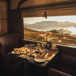 Sunlit cutlery and crockery on a table by the window