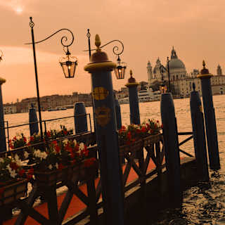 The hotel dock, with red carpet, flowers and lit lanterns, juts into the canal, opposite Basilica Santa Maria della Salute.