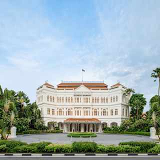 The iconic Raffles Singapore hotel dazzles with neo-Renaissance architecture, seen in full splendour, front on from the road.