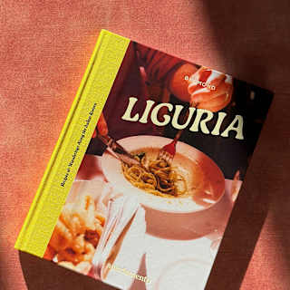 The cover of cookbook ‘Liguria: Recipes & Wanderings Along the Italian Riviera’ depicts a diner enjoying a bowl of spaghetti.