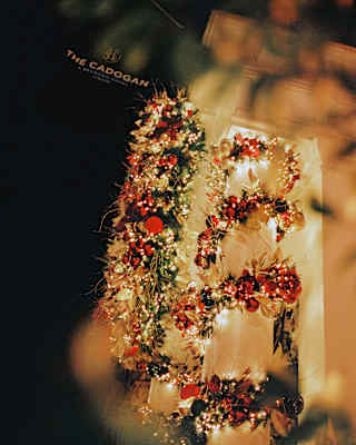The Cadogan hotel building decorated with festive garlands and lights at night.