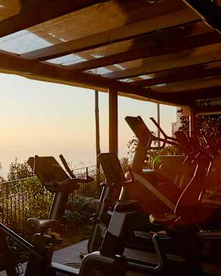 An outdoor gym enjoys views to die for, shaded from the sun by the terrace roof as the valley falls away below