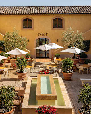 High-angle view over Tosca's beautiful courtyard with a central water feature comprising one rectangular pool inside another.