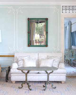 A Fumi Volumetric chair creates a modern splash in a vintage Serenissima Suite living room with a white sofa and blue walls.