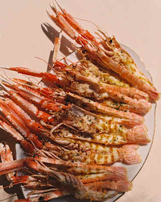 Looking down on a dish of eight butterflied and grilled langoustine with claws and tails, served at Cip's Club.