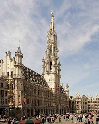 Tourists pack Brussels's Grand Place, flanked on all sides by tall gothic buildings, including the town hall and city museum.