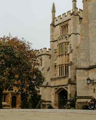 View of the Founders Tower at Magdalen college with neo-gothic turrets, stone mullion windows, leaded glass and grand arch.