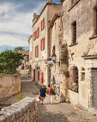 Aerial view of sandstone residences with wooden shutters in a rural French village
