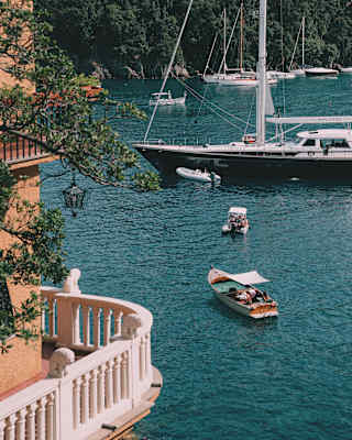 Aerial view of a curved balcony overlooking small fishing boats and yachts