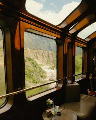 Champagne sits on a table in the Observation Car, where multiple windows and skylights bring the views into sharp relief.