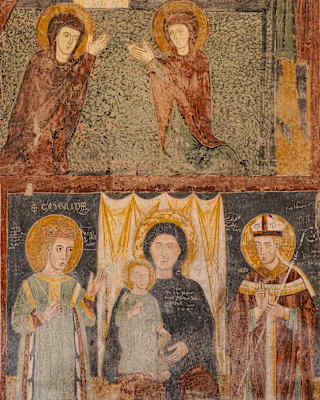 A religious fresco featuring two figures praying in the top register and a central seated figure holding a child, flanked by two standing figures in the bottom register.