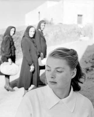 A still from Rossellini's film, Stromboli, shows Ingrid Bergman looking uneasy as she is watched by three local women.