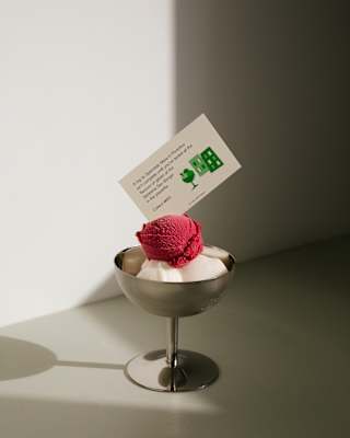 A card tucked into a bowl of fruity sorbet prompts the reader to try every flavour at Portofino's Gelateria San Giorgio.
