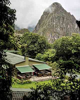 Lush gardens shroud two one-bedroom suites with outside sofas beneath green awnings and incredible views of Huchuy Picchu.