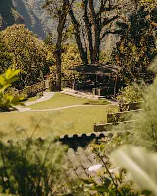 High-angle view across Sanctuary Lodge's rooftops to the stepped garden lawn, where a seating deck enjoys incredible views.