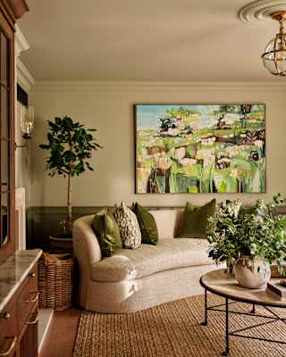 A nature-themed impressionist piece by Elaine Kazimierczuk adds a bright splash to a wall in the Artichoke Suite living room.