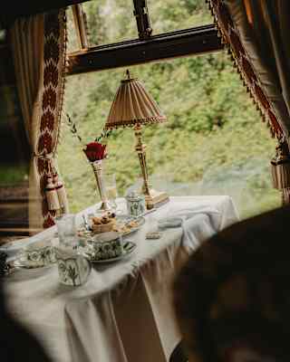 Angled image of a finished Afternoon Tea with tartlet crumbs and tea, served in William Edwards Sultan's Garden crockery.