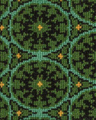The upholstery features a tiny yellow cross at the centre of aquamarine circle, on a green background filled with black zigzags