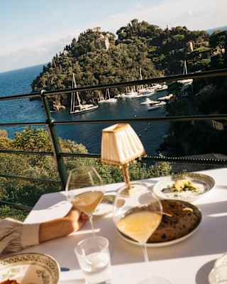 Diners at a table on the terrace of Splendido Grill sit back from their plates and drinks to digest the extraordinary views.