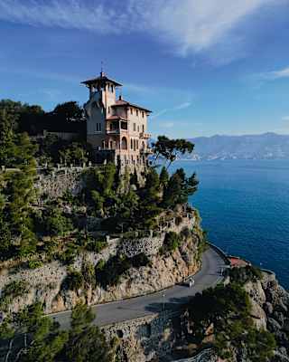 The characterful towering Villa Beatrice perches in pine-filled gardens on a headland overlooking the azure Ligurian Sea.