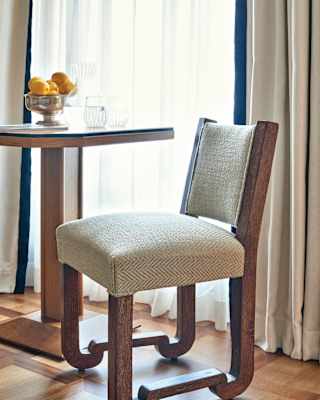 Close-up of a herringbone Italian knit chair at a table with a lemon centrepiece