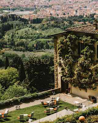 View over the hotel gardens and green hills down to the city of Florence and its pretty collection of terracotta rooftops.