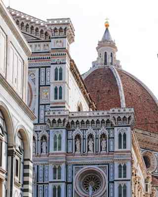 The exterior walls of Florence Cathedral, Duomo di Firenze, clad in decorative white, pink, grey and green marble panels