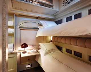 Lamplit train cabin with bunk beds and elegant cream and beige accents