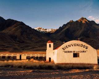 The Andean Explorer stopped near an old church in La Raya with the inscription Bienvenidos "Señor de la Caña"