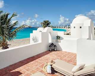 Roof terrace with sun beds overlooking an Anguilla beach