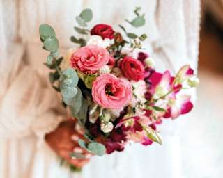Elegant wedding bouquet held by woman in white dress