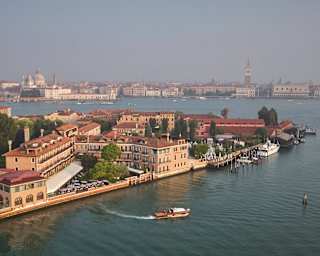 The Hotel Cipriani’s launch leaves a wake as it pulls away from the private dock. Behind, the iconic pink walls stand majestic