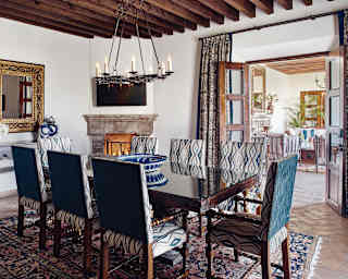 Hotel suite dining area with woven carpet and stone fireplace