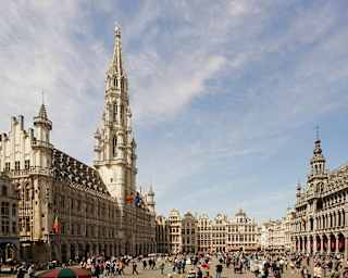 Tourists pack Brussels's Grand Place, flanked on all sides by tall gothic buildings, including the town hall and city museum.