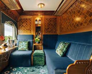 With two blue velvet banquettes, green cushions, and sublime cherry wood marquetry, the State Cabin is a jewel of elegance.