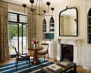 A Garden Cottage room promotes homeliness with wall cabinets of curios, fireplace, warm furnishings and doors to gardens.