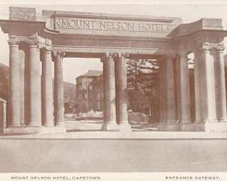 A sepia print of Mount Nelson Hotel's entrance gateway, taken circa 1925, with glimpses of the grounds through its columns.