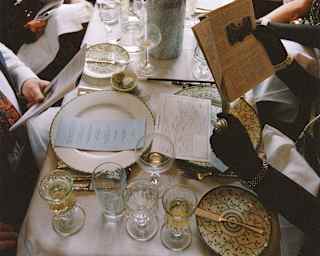 Looking down on a dining table busy with glasses and crockery as guests peruse the menu and their Murder Mystery evidence.