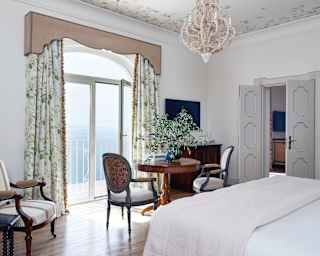 The Belvedere suite boasts smooth floorboards, vintage pieces and hand-painted frescos, and a Juliet balcony with sea views.
