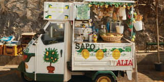 Ape Calessino car converted into a lemonade stand and painted with lemon patterns