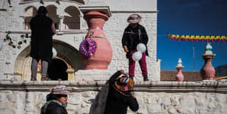 Local women string up garlands and white balloons as they decorate the church in the town of Maca in the Colca Valley.