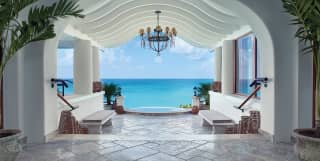 Stone tiled entrance hall with vaulted archway and Caribbean sea beyond