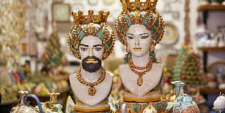 An exotic couple of figurines in a colourful collection of ceramic art in Taormina