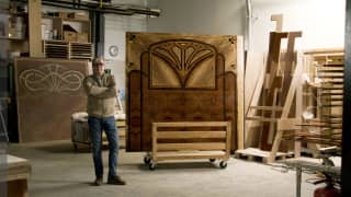 In his workshop, expert marquetry craftsman, Philippe Allemand stands, arms folded, by a finished panel for La Forêt Suite.