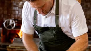 Chef Curtis Stone spoons spices from ramekins in a careful preparation of Beef Tartare on the marble counter at  Woodend.