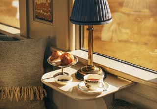 A breakfast on a table by the window in the dining car